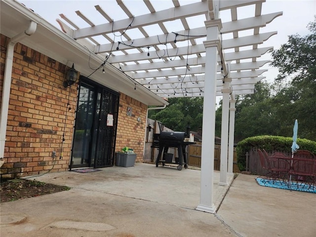 view of patio with a pergola and grilling area