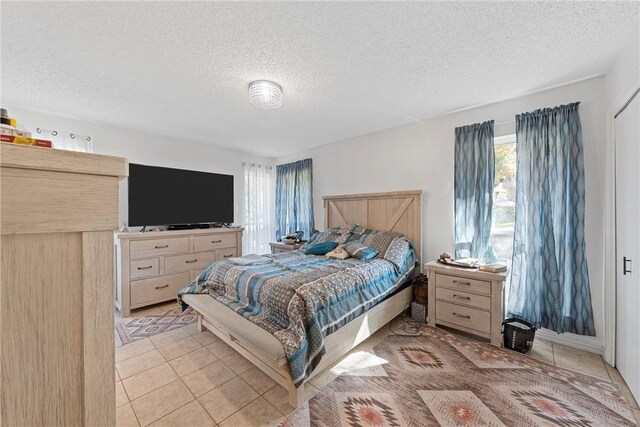 tiled bedroom with a textured ceiling