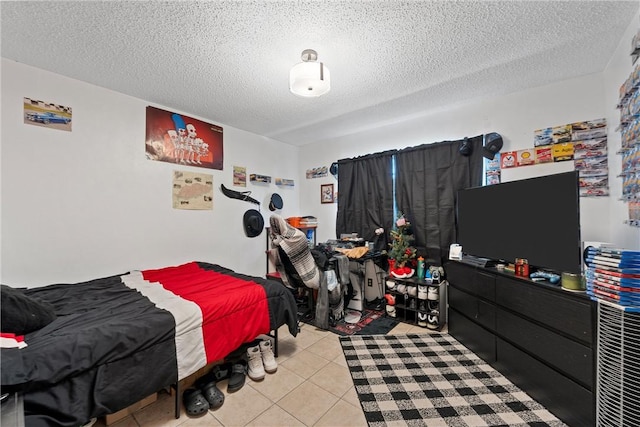 bedroom featuring light tile patterned floors and a textured ceiling