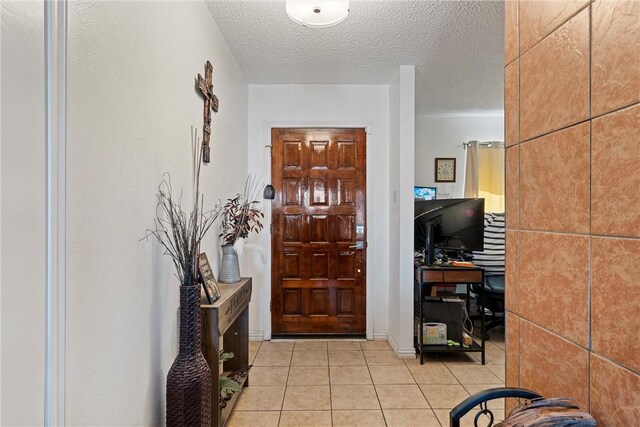 tiled foyer entrance with a textured ceiling