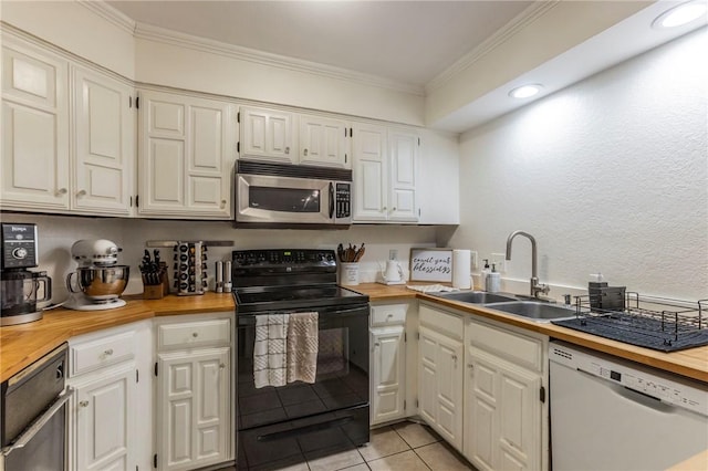 kitchen with butcher block counters, stainless steel microwave, black electric range oven, white dishwasher, and a sink