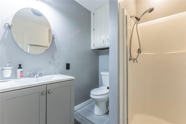 bathroom featuring a shower, vanity, toilet, and tile patterned floors