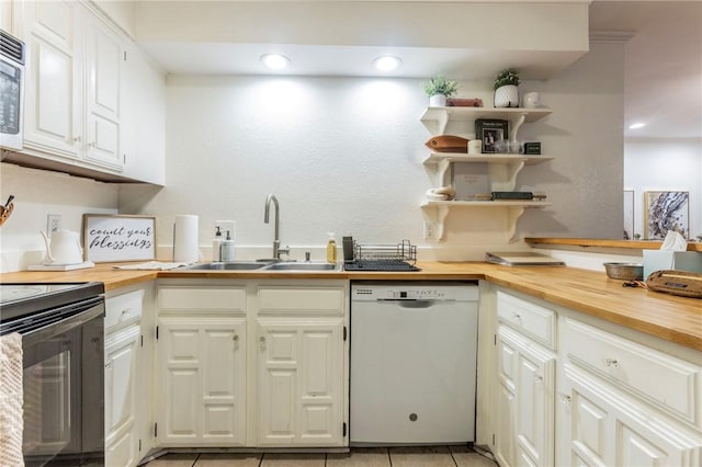 kitchen with electric range, a sink, wooden counters, dishwasher, and stainless steel microwave