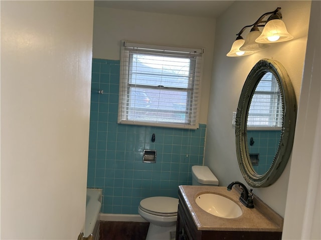 bathroom featuring vanity, plenty of natural light, and toilet