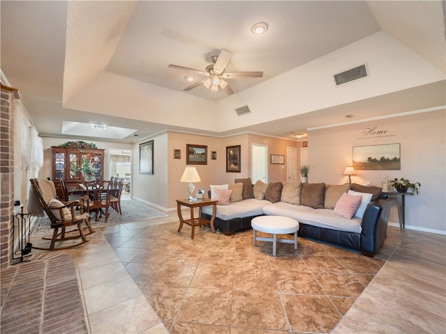 living room featuring tile patterned flooring, high vaulted ceiling, a raised ceiling, and ceiling fan