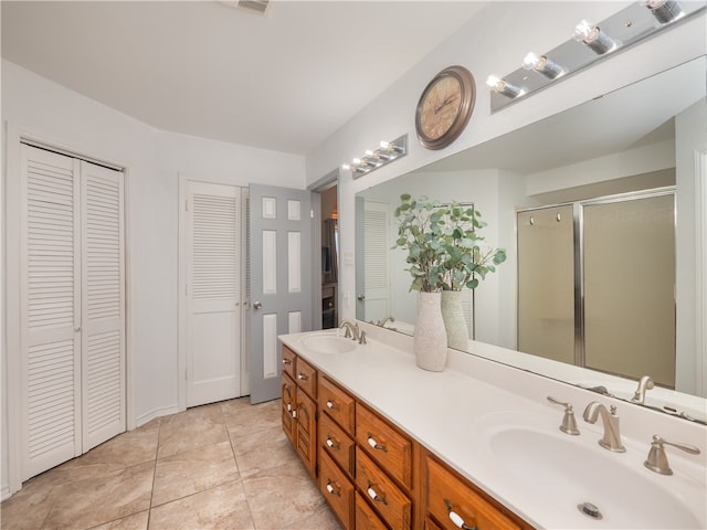 bathroom with vanity, an enclosed shower, and tile patterned flooring