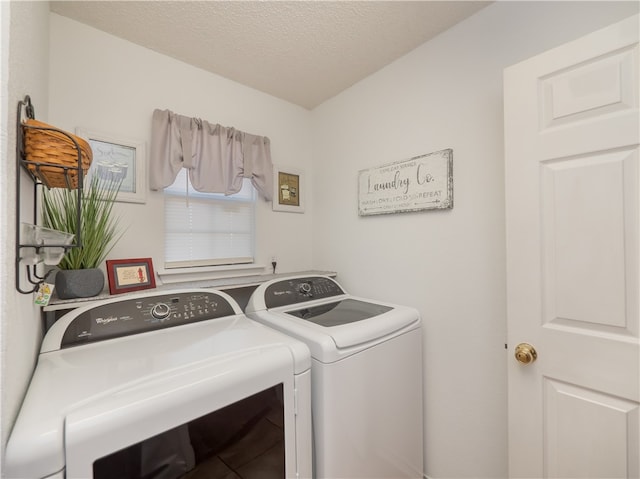 washroom featuring washer and dryer and a textured ceiling