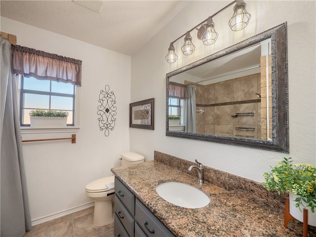 bathroom featuring tile patterned flooring, vanity, a textured ceiling, curtained shower, and toilet