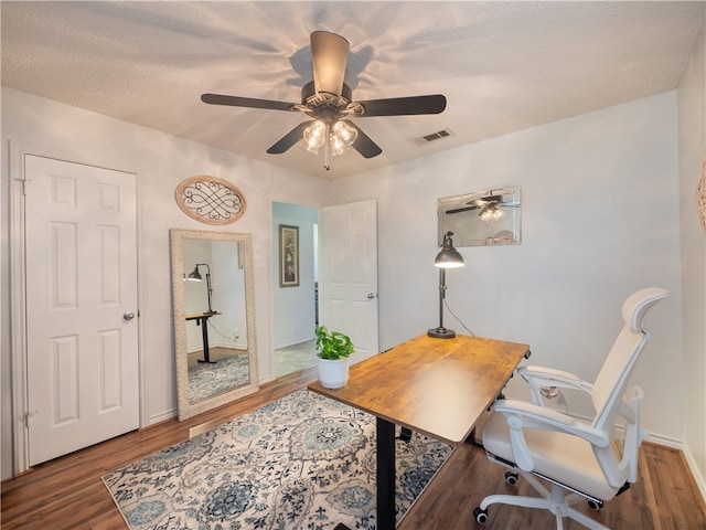 office space with ceiling fan, dark hardwood / wood-style floors, and a textured ceiling