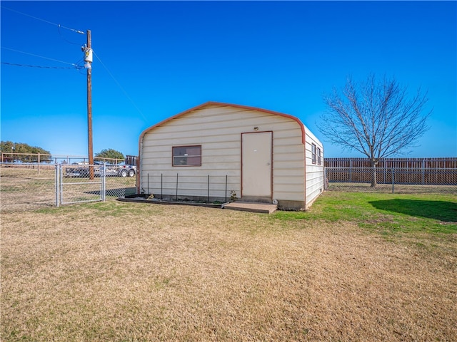 view of outbuilding with a yard