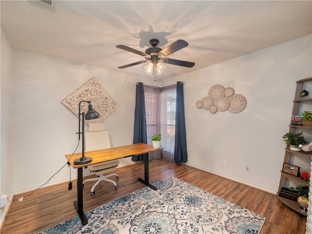 office area featuring hardwood / wood-style flooring, ceiling fan, and a textured ceiling