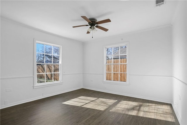 unfurnished room with dark hardwood / wood-style floors, a wealth of natural light, and ceiling fan