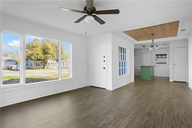 unfurnished living room with dark hardwood / wood-style flooring and ceiling fan with notable chandelier