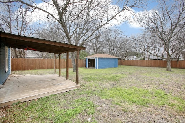 view of yard with a wooden deck and a storage shed