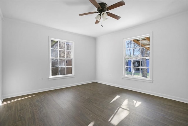 spare room with a healthy amount of sunlight, dark wood-type flooring, and ceiling fan