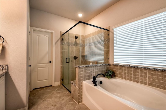 bathroom featuring tile patterned floors, vanity, and shower with separate bathtub