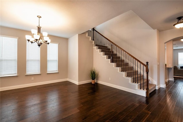 interior space with dark hardwood / wood-style flooring and a notable chandelier