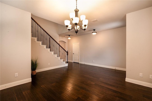 interior space with a chandelier and dark hardwood / wood-style floors