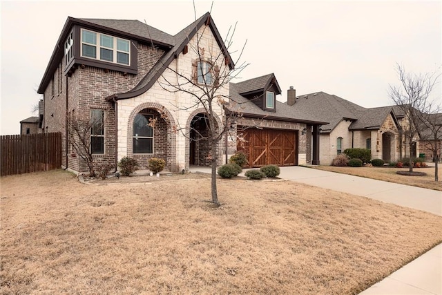 view of front of home featuring a front yard and a garage