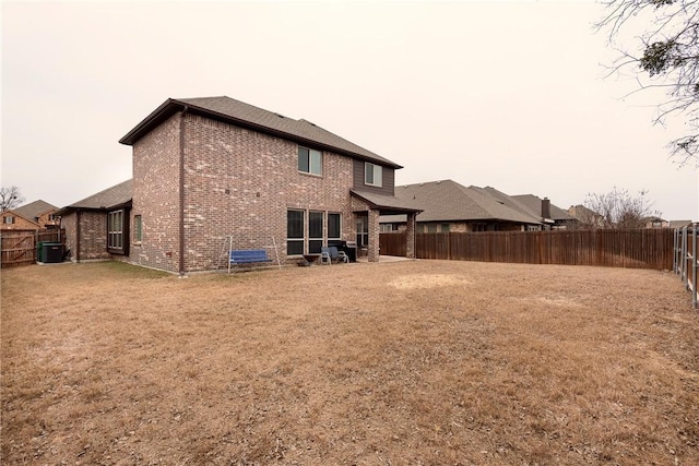 rear view of property with a lawn