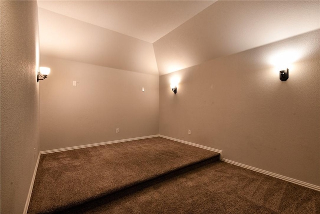 unfurnished room featuring carpet flooring and vaulted ceiling