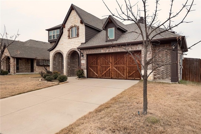 view of front of property featuring a front yard and a garage