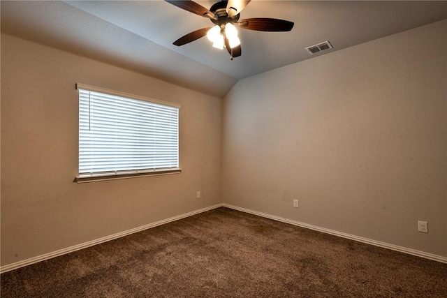 empty room with ceiling fan, dark carpet, and vaulted ceiling