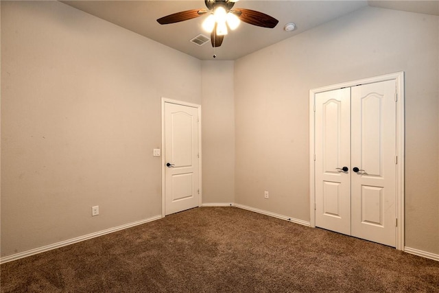 carpeted spare room featuring ceiling fan and vaulted ceiling