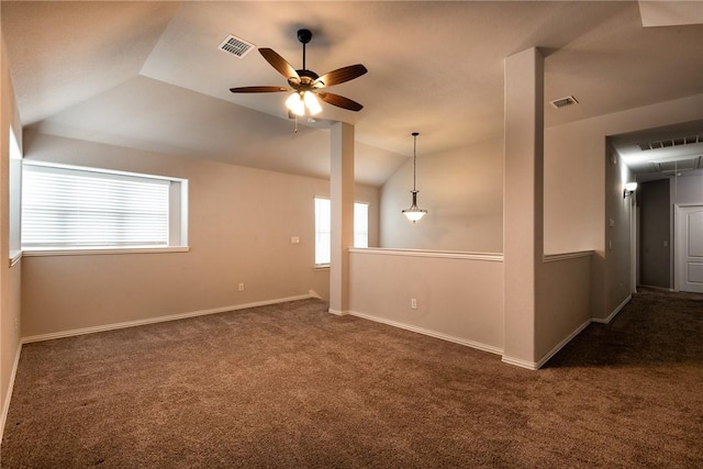 carpeted spare room featuring ceiling fan and vaulted ceiling