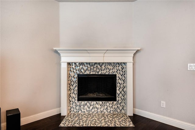 details with wood-type flooring and a tile fireplace