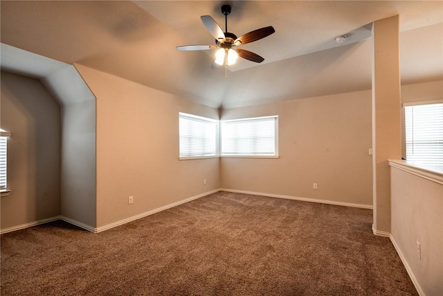 carpeted spare room featuring ceiling fan and lofted ceiling