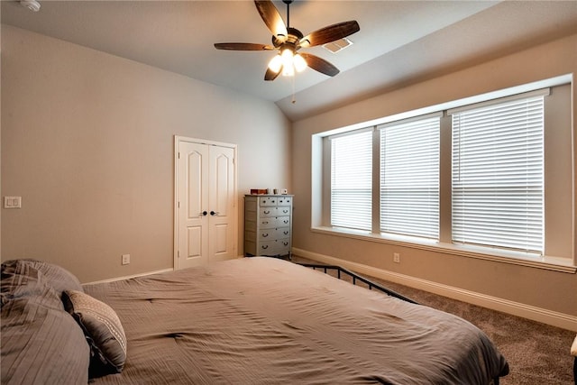 bedroom with ceiling fan, vaulted ceiling, carpet, and a closet