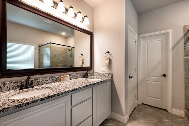 bathroom with vanity, tile patterned floors, and a shower with door