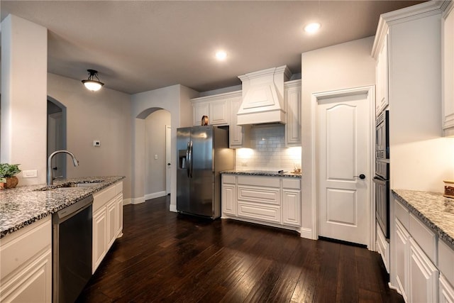 kitchen with black appliances, sink, dark wood-type flooring, white cabinets, and light stone counters