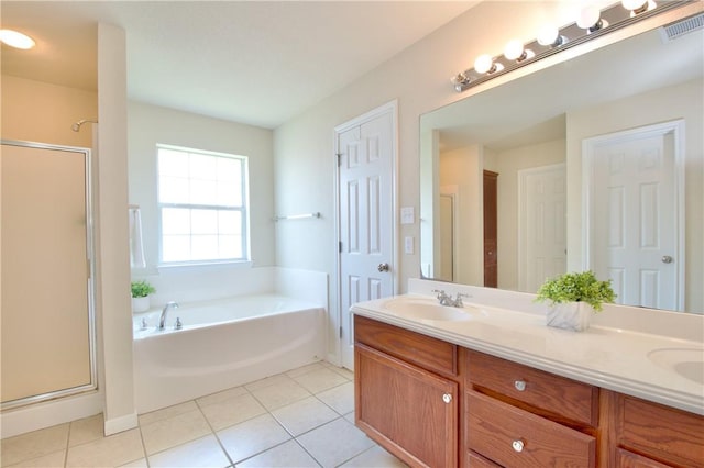 bathroom with shower with separate bathtub, vanity, and tile patterned floors