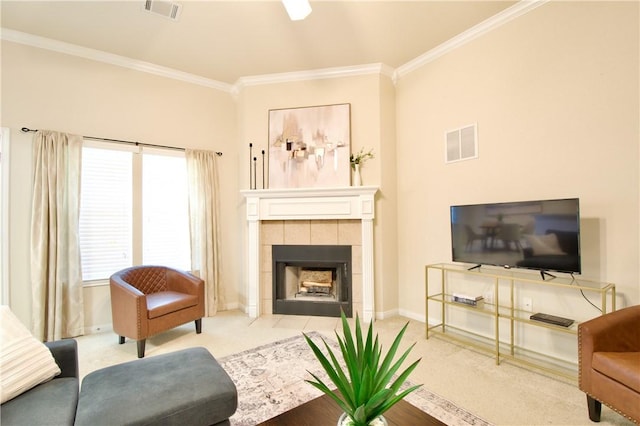 carpeted living room featuring ornamental molding and a tiled fireplace