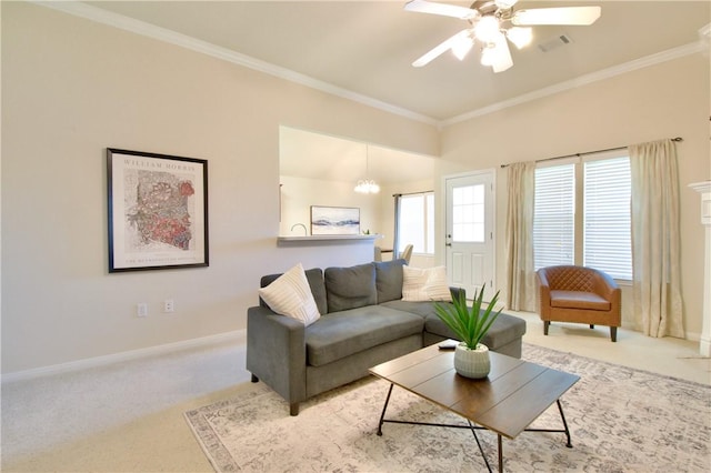 carpeted living room featuring ceiling fan with notable chandelier and ornamental molding