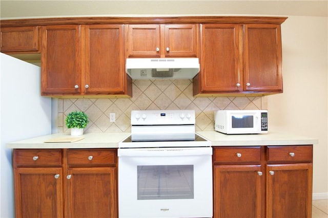 kitchen featuring white appliances and backsplash