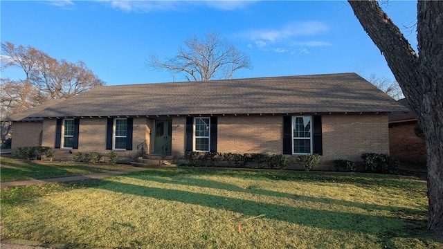 single story home with a front yard and brick siding