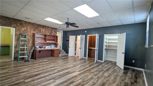 interior space featuring stairway, wood finished floors, a paneled ceiling, and a ceiling fan