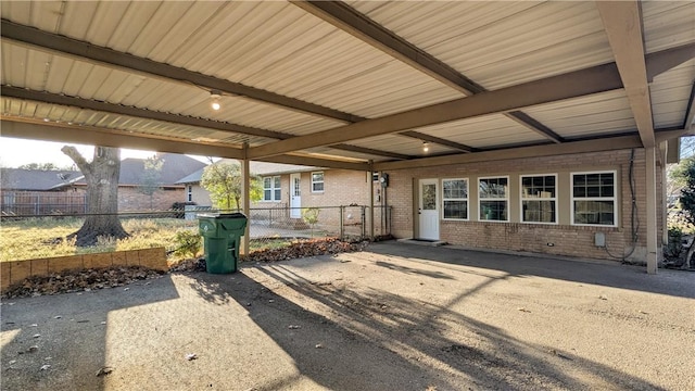 property entrance with fence and brick siding