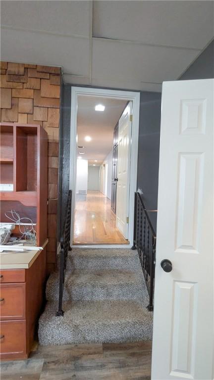 stairs featuring wood finished floors