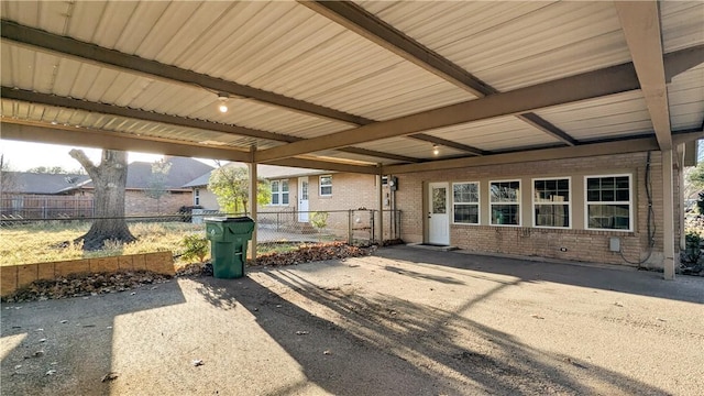 exterior space featuring brick siding and fence