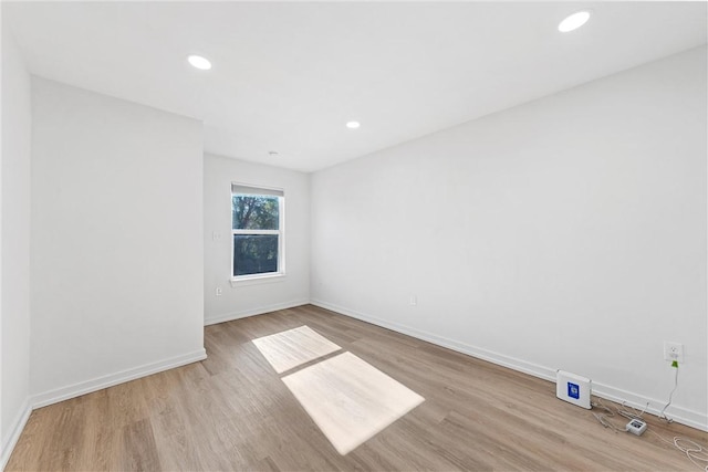 spare room with light hardwood / wood-style flooring