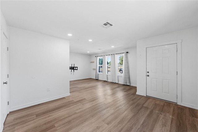 empty room with light hardwood / wood-style floors