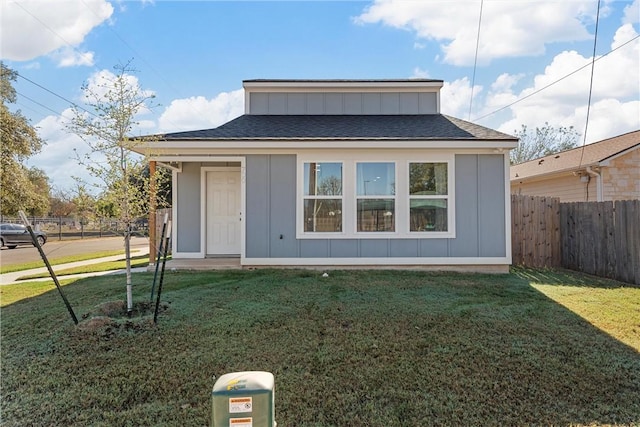 rear view of house with a lawn