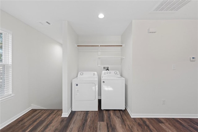 clothes washing area with independent washer and dryer and dark wood-type flooring