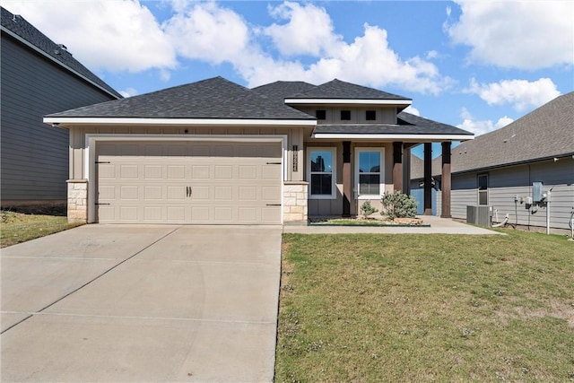 view of front of home with a garage, central air condition unit, and a front lawn