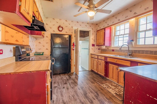 kitchen with black refrigerator, ceiling fan, sink, electric range, and hardwood / wood-style floors