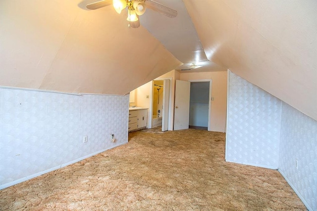 bonus room with ceiling fan, light colored carpet, and lofted ceiling